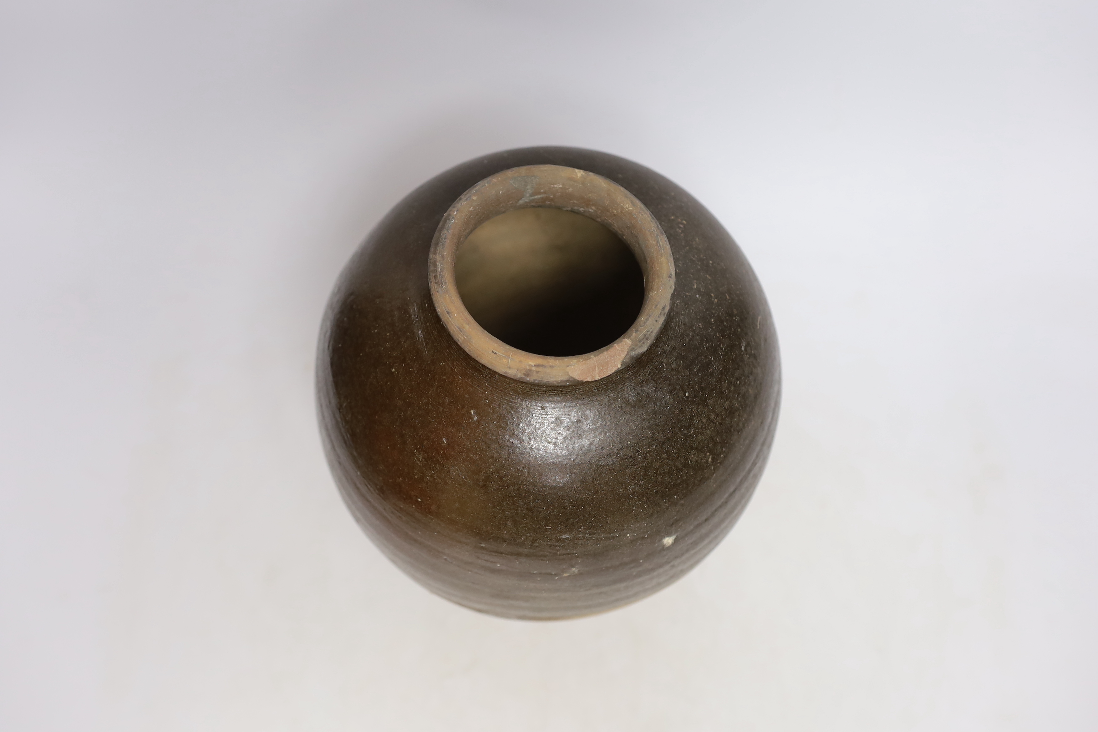 A Chinese brown partially glazed jar, Tang dynasty, 26cm